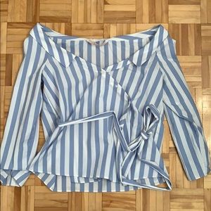 Off the shoulder baby blue striped shirt.